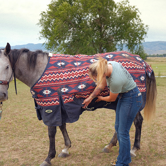 Woman fitting horse blanket